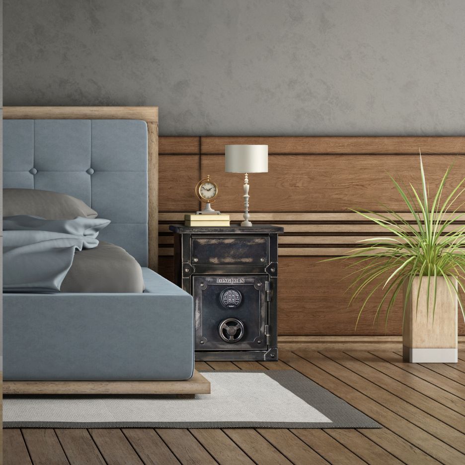 Small safe used as a nightstand in bedroom.