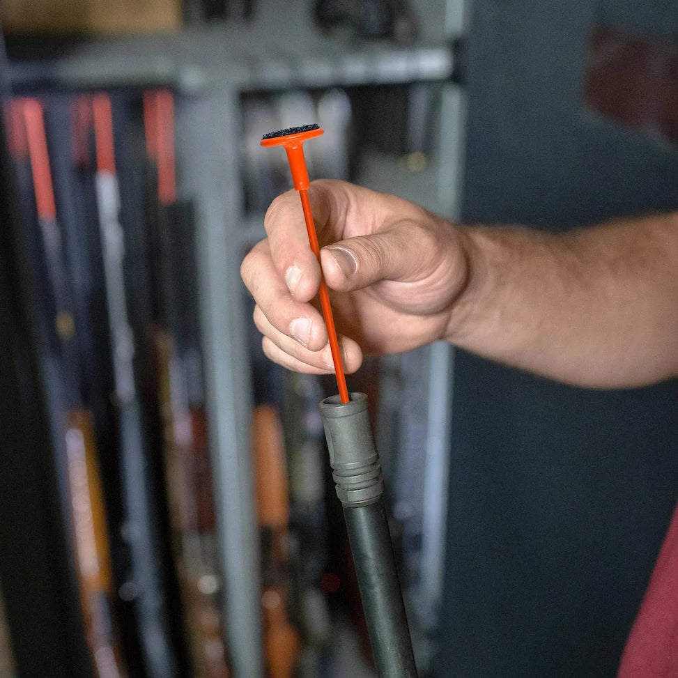 Close-up of a Liberty Orange Rifle Rod used to organize long guns inside a gun safe
